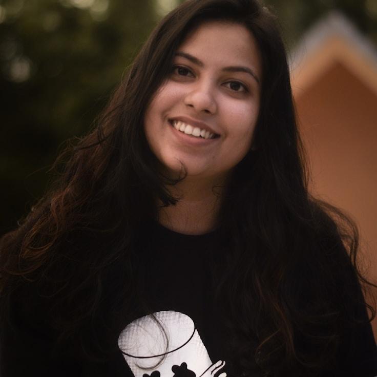 Kaveri Mehta, Lead Design Curator at PixelBytePress, reviewing corporate floral arrangements